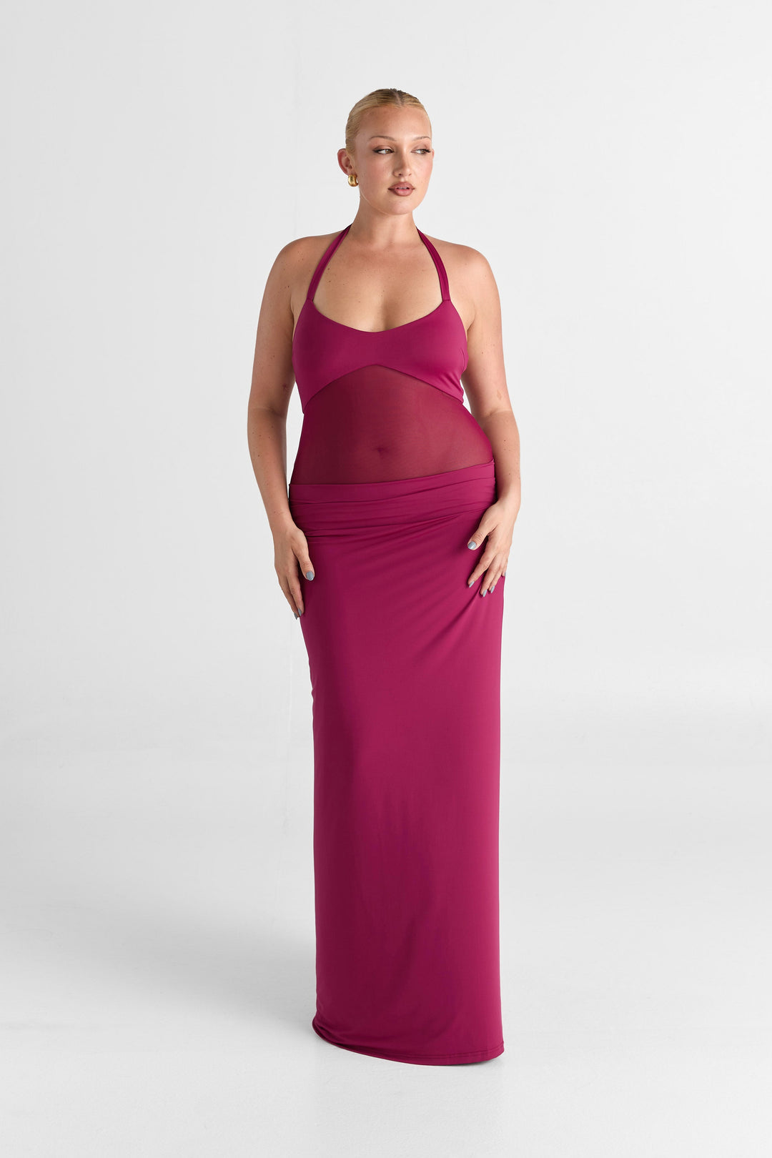 Woman wearing a pink dress on a white background