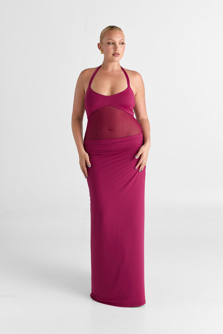 Woman wearing a pink dress on a white background